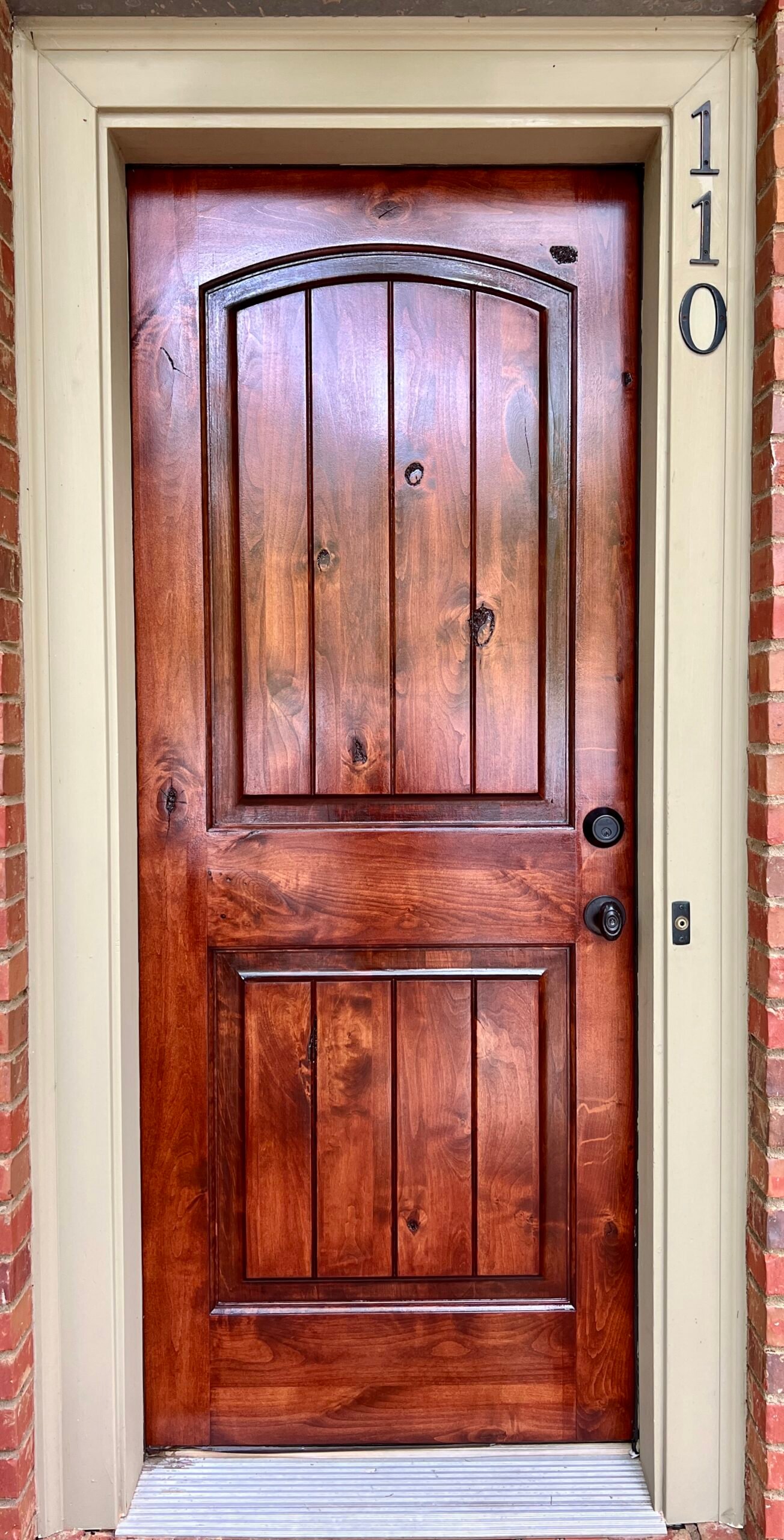 Newly restored wooden door with a pristine, polished finish