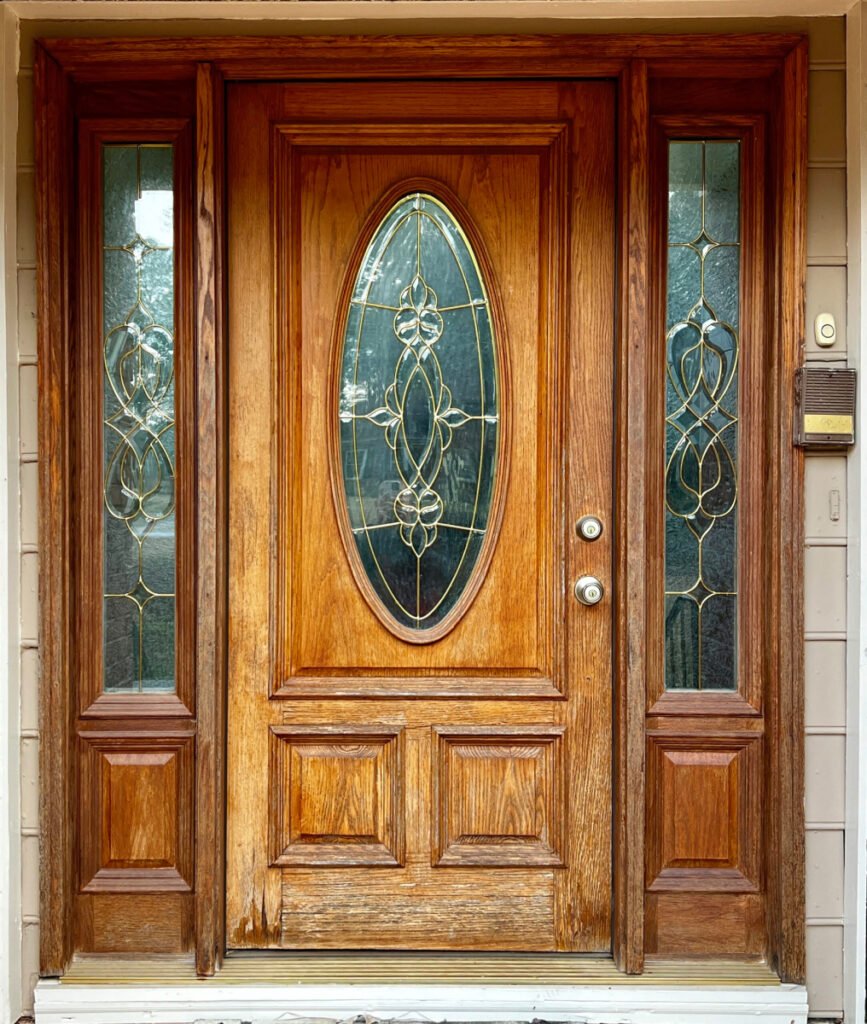 Vintage wooden door with a weathered appearance, showing signs of age and character.