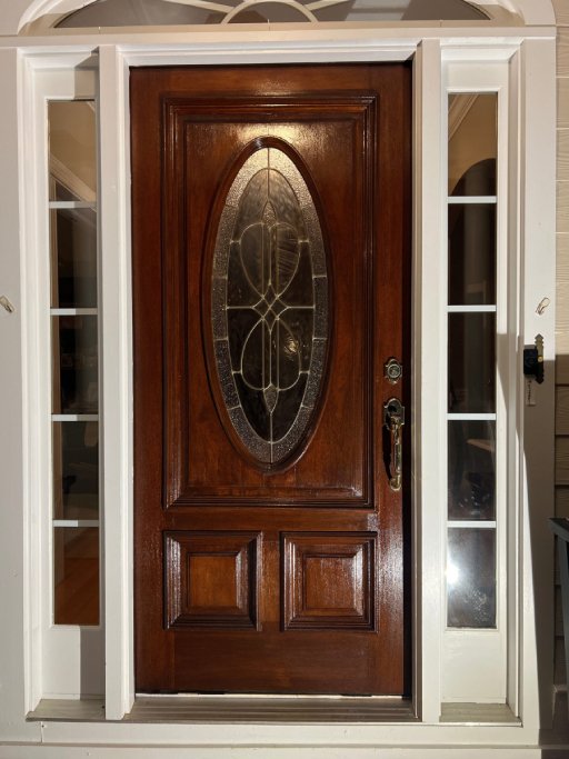 Restored wooden door with a smooth, polished finish, highlighting its renewed elegance