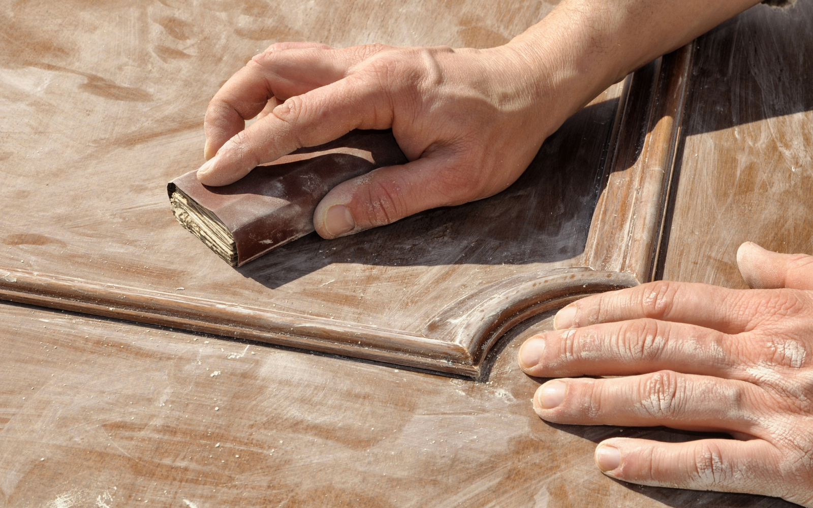 polishing a wooden door
